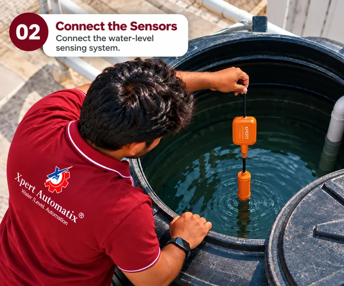 An engineer lowering the water-level sensor into the overhead tank